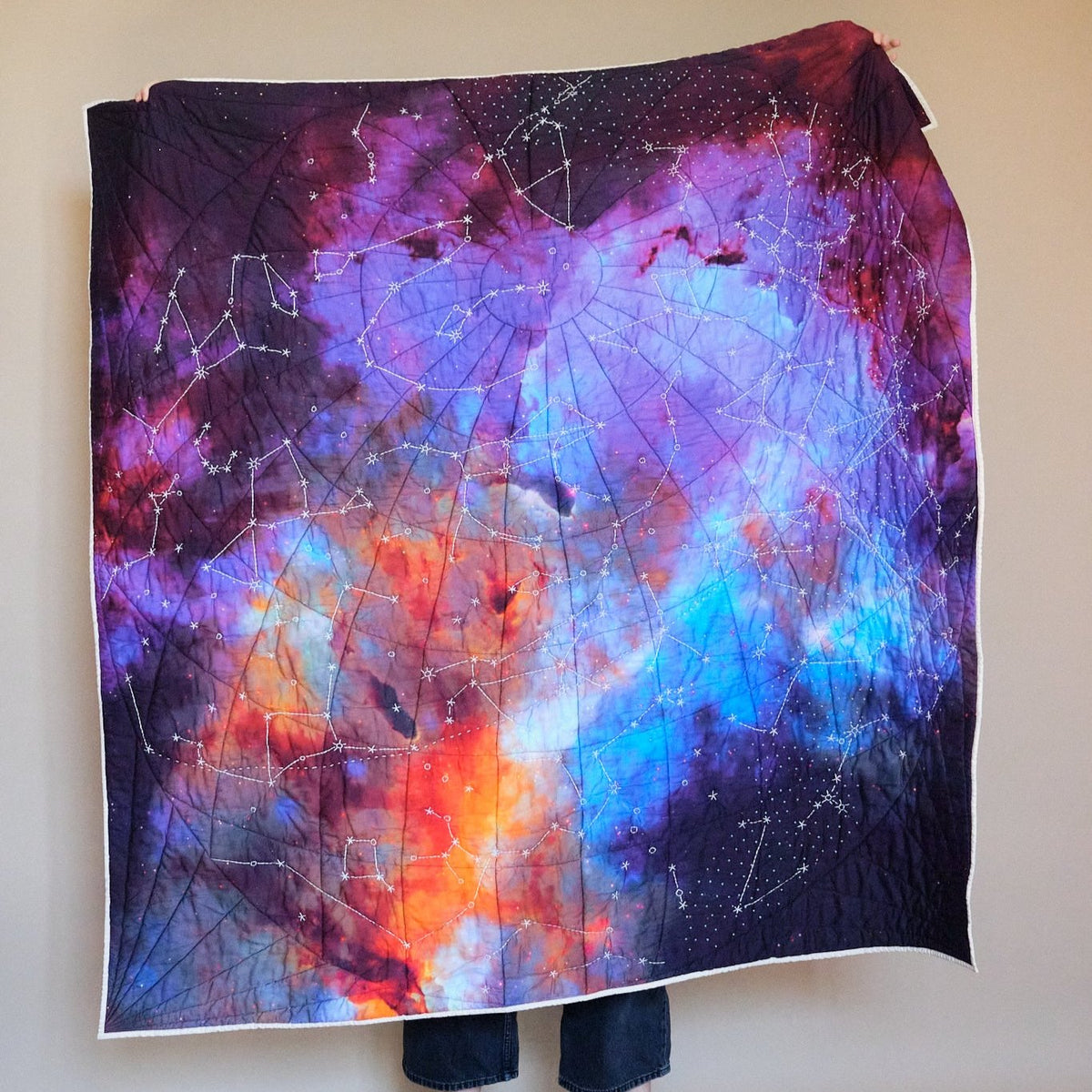 Galileo Quilt by Haptic Lab. Embroidered constellation quilt on James Webb Telescope imagery