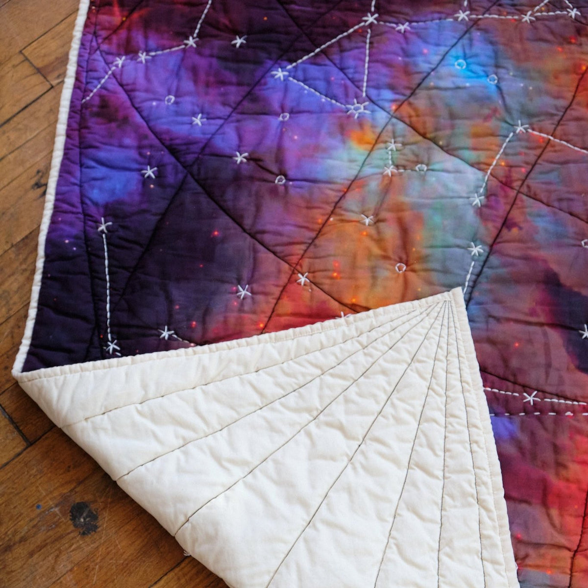 Galileo quilt with corner turned up_ back of quilt is ivory