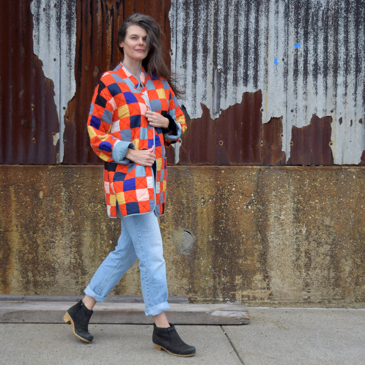 Emily wearing a red patchwork quilt coat